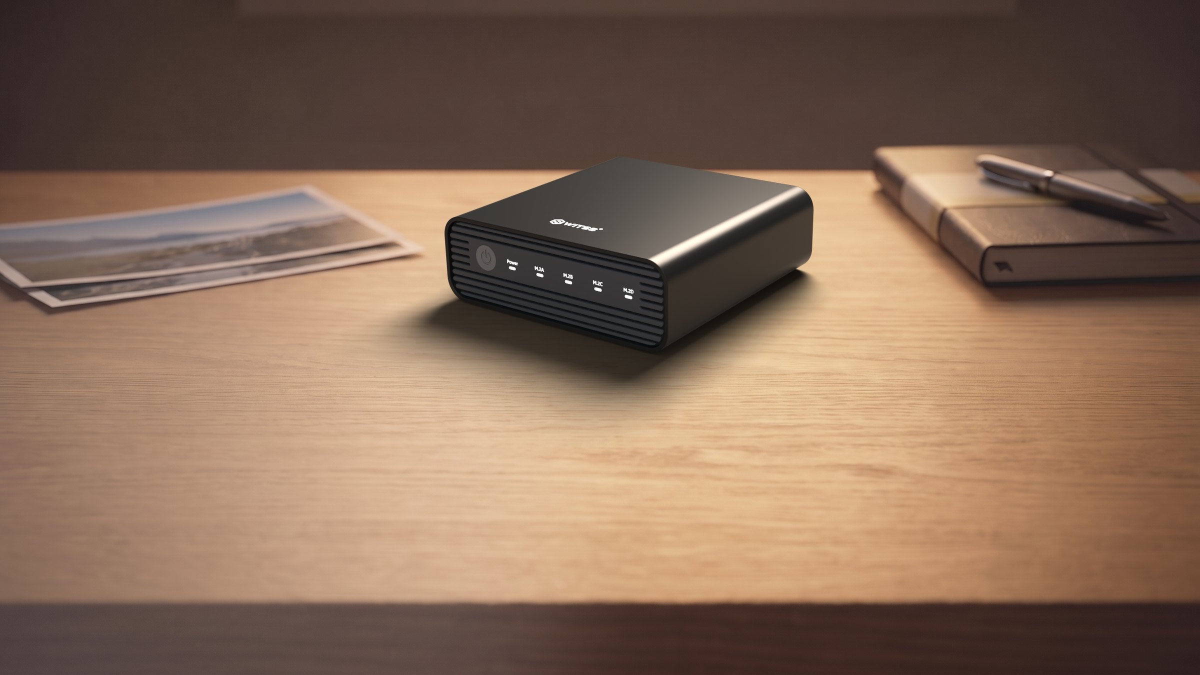 Switss® 4-Bay M.2 RAID enclosure USB4 40 Gbps on a wooden desk, lifestyle shot