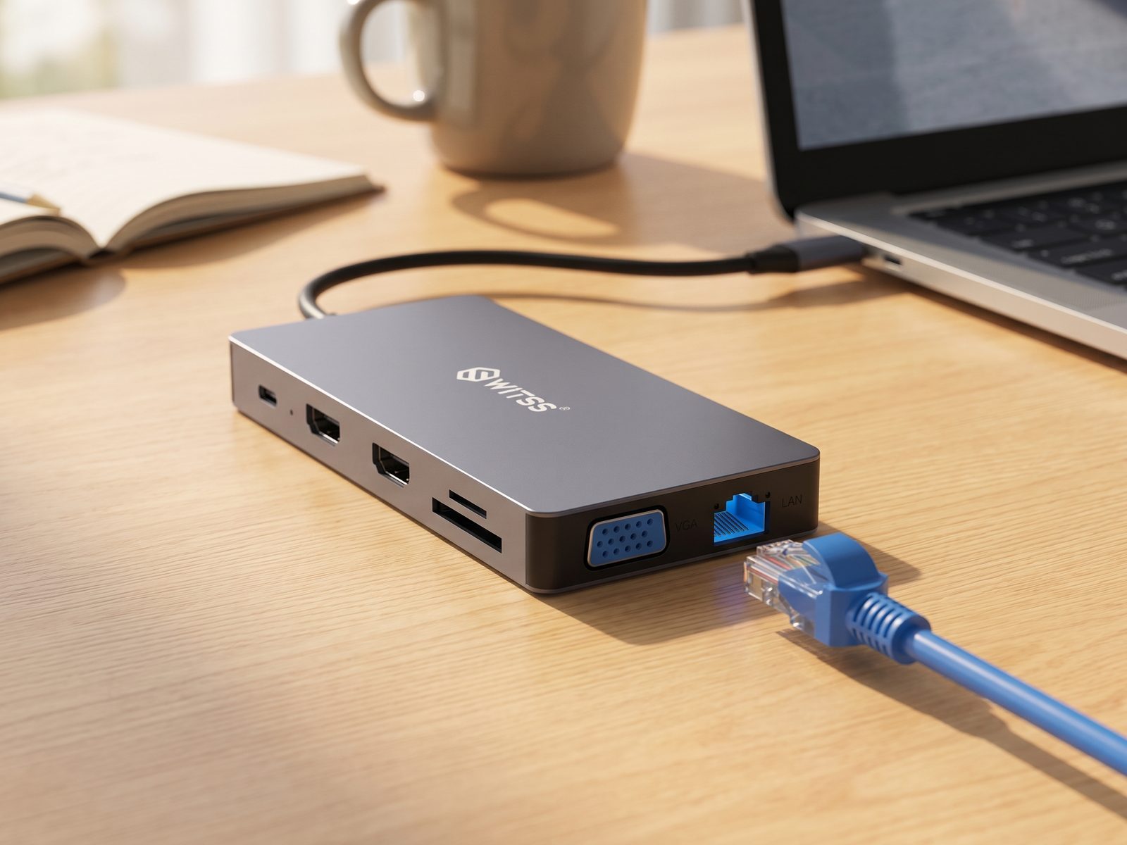 Switss® 12-in-1 hub on a desk next to a laptop, network cable ready by the ethernet port