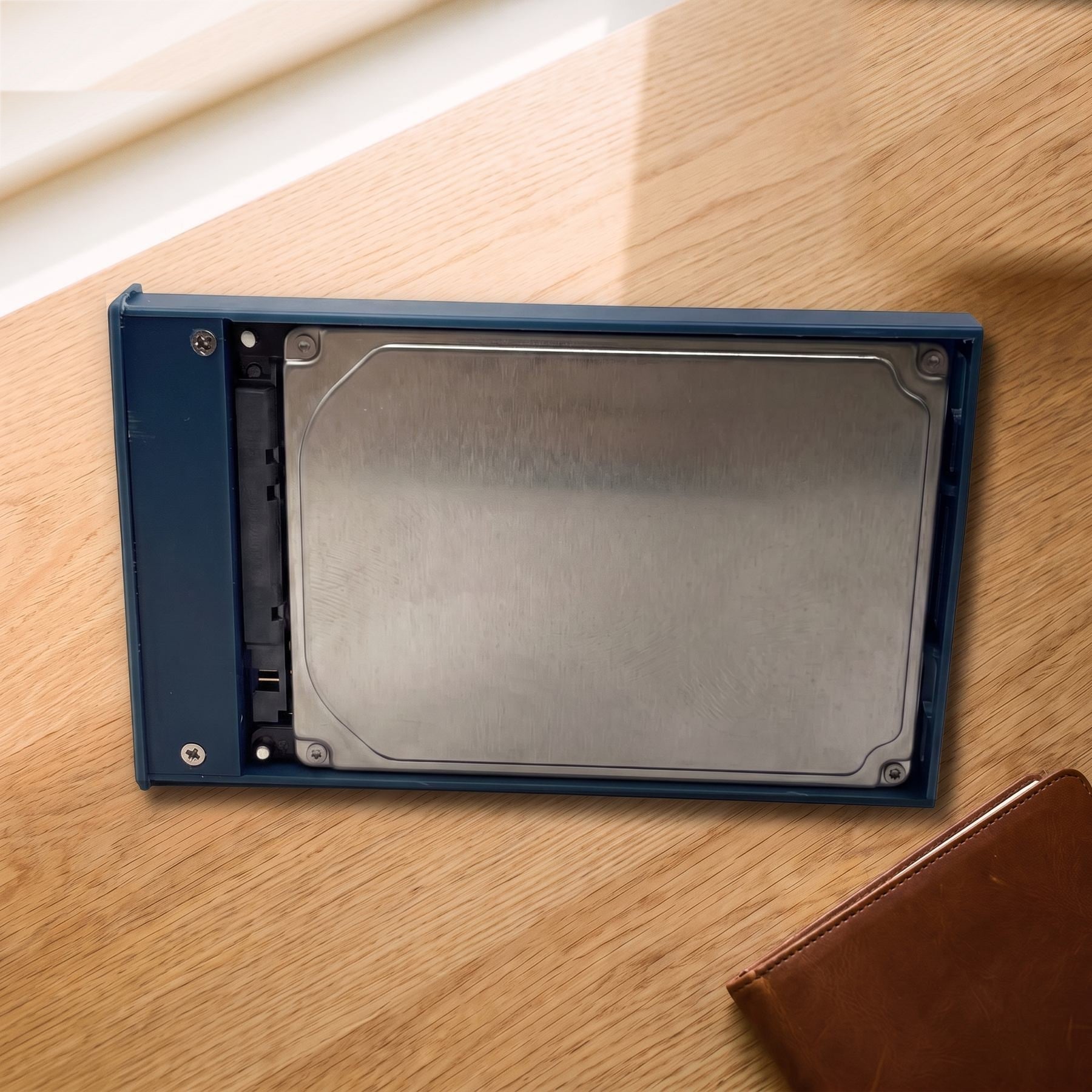 Open blue enclosure with a 2.5 inch drive on the connector